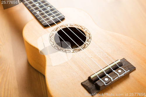 Image of Ukulele on wood background