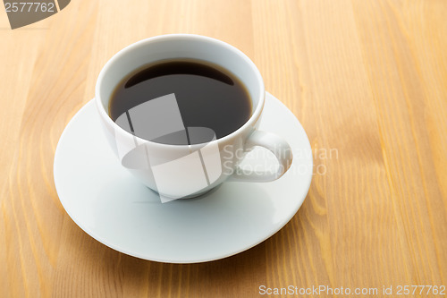 Image of Cup of coffee on wooden table