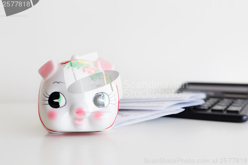 Image of Piggy bank, calculator and statement