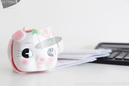 Image of Piggy bank, calculator and statement