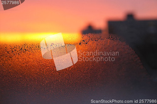 Image of Background with ice, morning sunlight and silhouettes of houses 