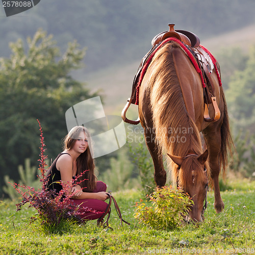 Image of Young girl with a horse