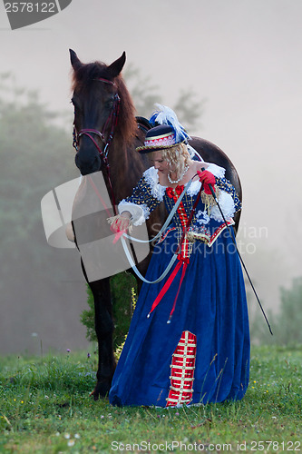 Image of Woman in dress royal baroque riding