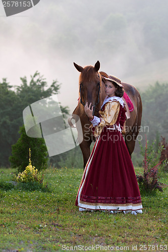 Image of Woman in dress royal baroque riding