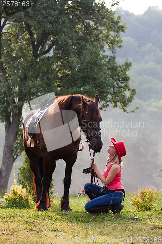 Image of Woman in red hat riding