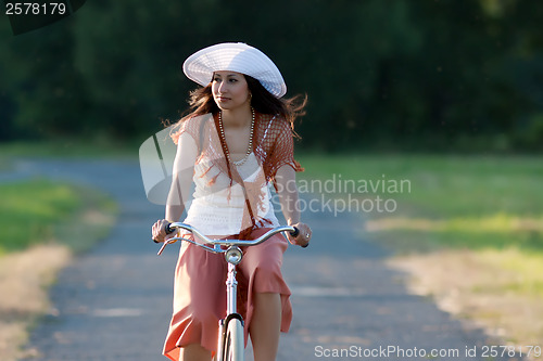 Image of Retro girl on old bike