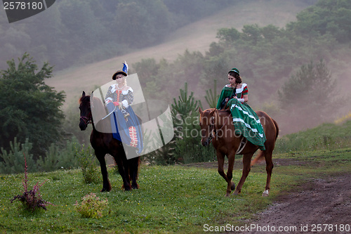 Image of Two women in the royal baroque dress riding