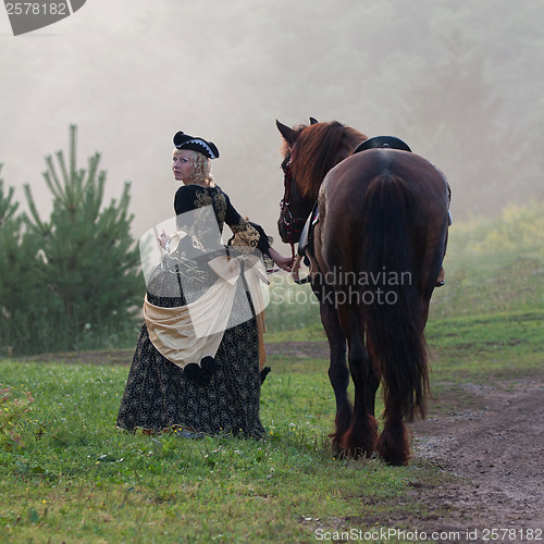 Image of Woman in dress royal baroque riding