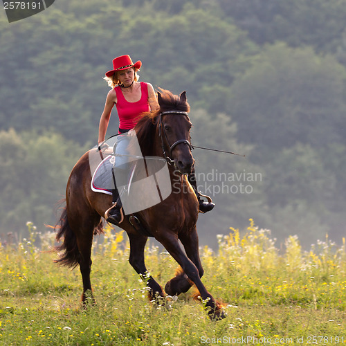 Image of Woman in red hat riding