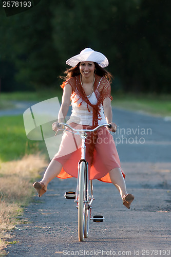 Image of Retro girl on old bike