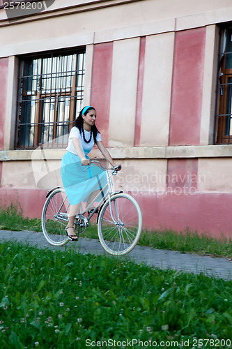 Image of Retro girl on old bike