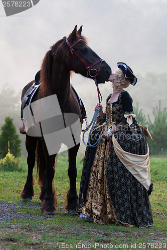 Image of Woman in dress royal baroque riding