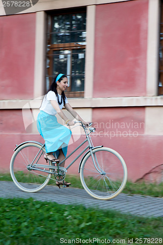 Image of Retro girl on old bike