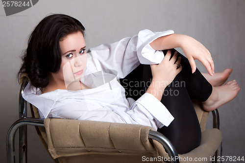 Image of Portrait of long-haired woman in a white men's shirt