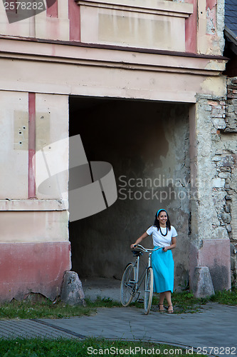 Image of Retro girl on old bike