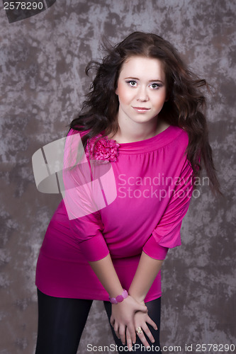 Image of Girl with long hair in a pink blouse