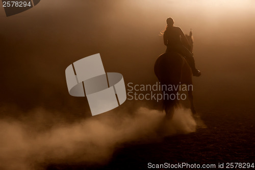 Image of Horse riding in the dust