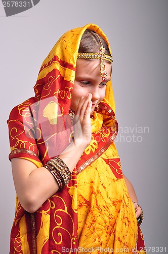 Image of little girl in traditional Indian clothing dancing