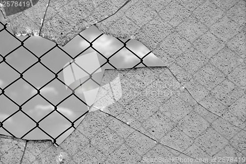 Image of broken glass and wired fence