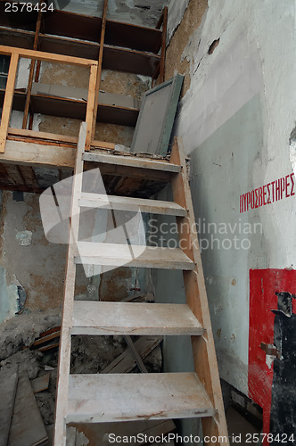 Image of crumbling attic and wooden stairs