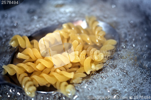 Image of fusilli pasta in boiling water