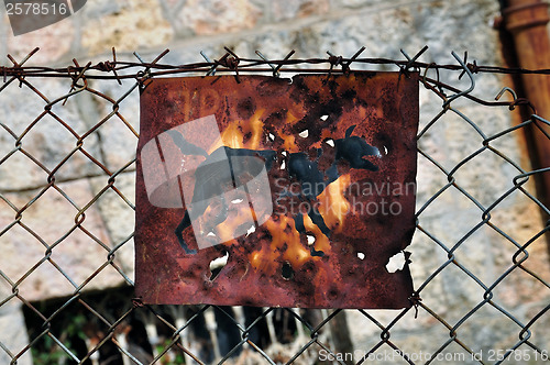 Image of rusty beware of the dog sign