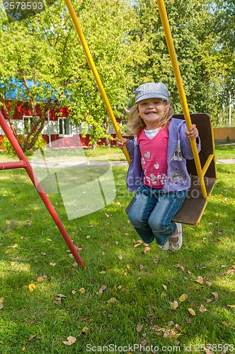 Image of Smiling girl on swing