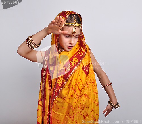 Image of child in traditional Indian clothing and jeweleries dancing