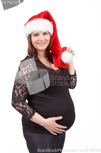 Image of beautiful pregnant woman tenderly holding her tummy isolated on 