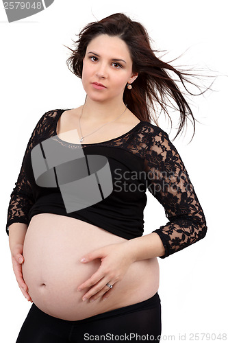 Image of beautiful pregnant woman tenderly holding her tummy isolated on white background