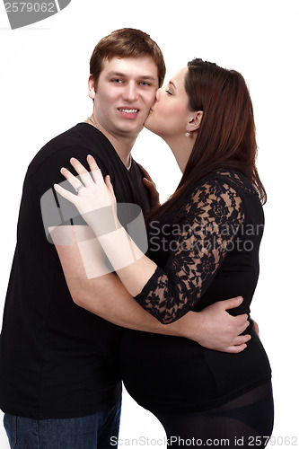 Image of loving happy couple, woman kissing her husband