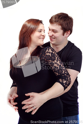 Image of loving happy couple, smiling pregnant woman with her husband