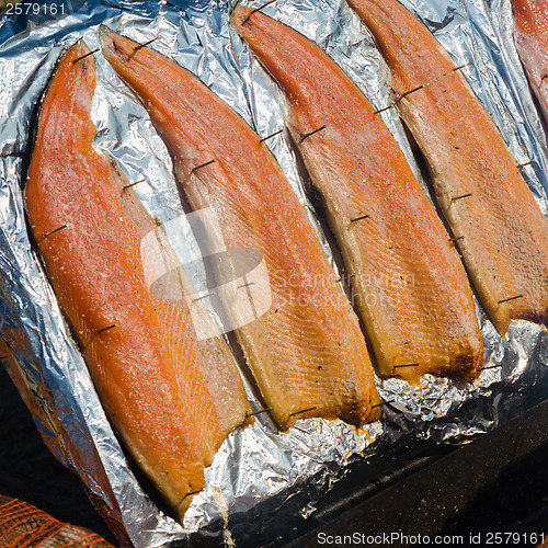 Image of salmon fillet roasted on coals, close-up