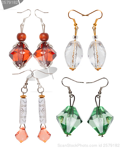 Image of Earrings made of plastic and glass on a white background. Four p
