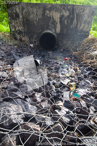 Image of environmental pollution. engine oil from a pipe
