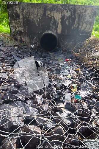 Image of environmental pollution. engine oil from a pipe