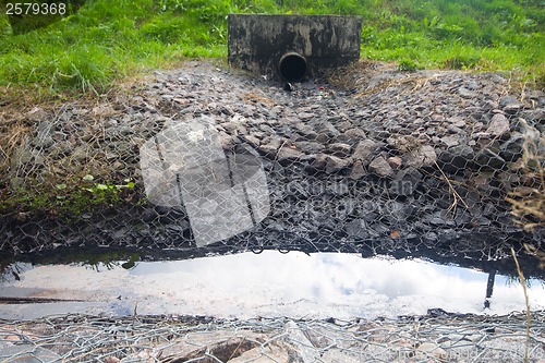 Image of environmental pollution. engine oil from a pipe