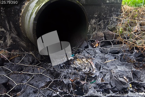 Image of environmental pollution. engine oil from a pipe