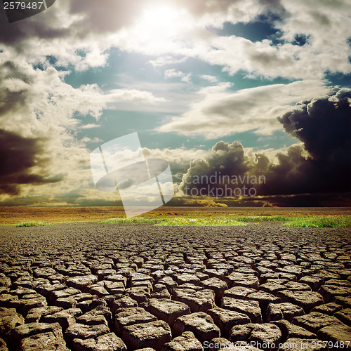 Image of hot sun over drought earth with cracks