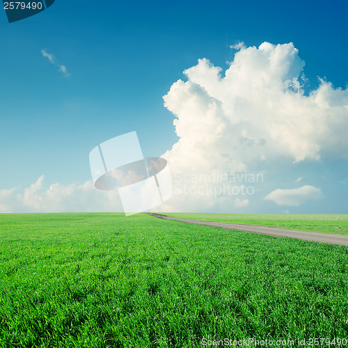 Image of clouds in blue sky over green grass