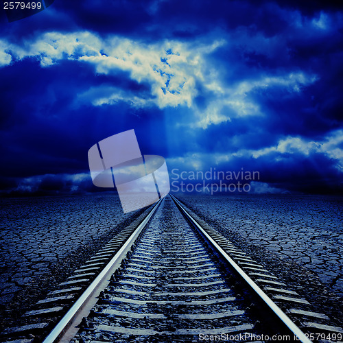 Image of railroad in night to cloudy horizon