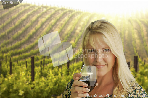 Image of Attractive Woman Enjoying a Glass of Wine at the Vineyard