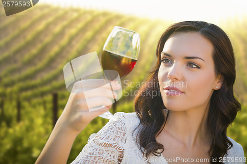 Image of Young Adult Woman Enjoying A Glass of Wine in Vineyard