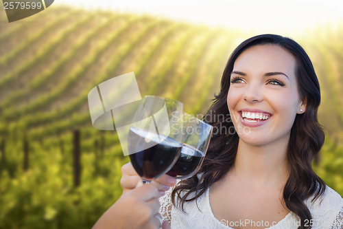 Image of Young Woman Enjoying Glass of Wine in Vineyard With Friends