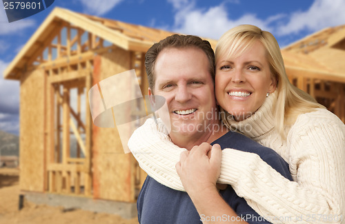 Image of Couple in Front of New Home Construction Framing Site