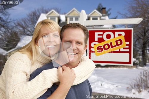 Image of Couple in Front of New House and Real Estate Sign