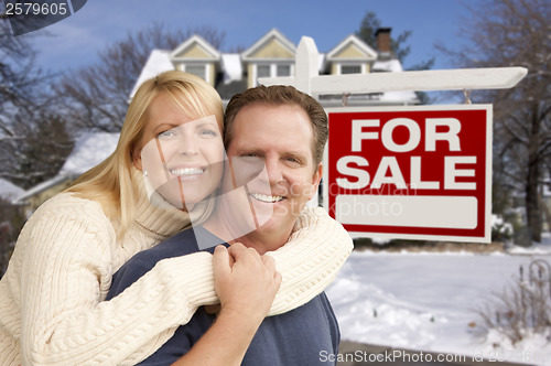 Image of Couple in Front of New House and Real Estate Sign
