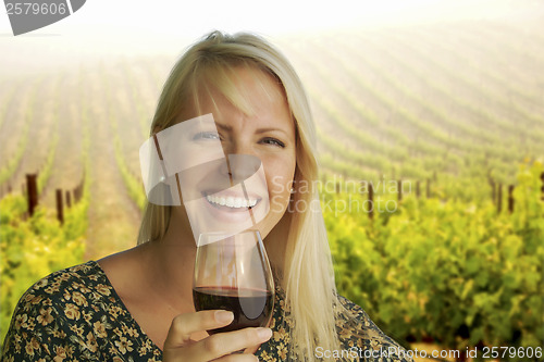 Image of Attractive Woman Enjoying a Glass of Wine at the Vineyard