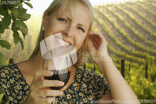 Image of Attractive Woman Enjoying a Glass of Wine at the Vineyard