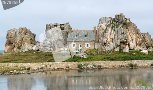 Image of house between rock formation